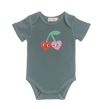 Green baby onesie with cherry heart design on a white background